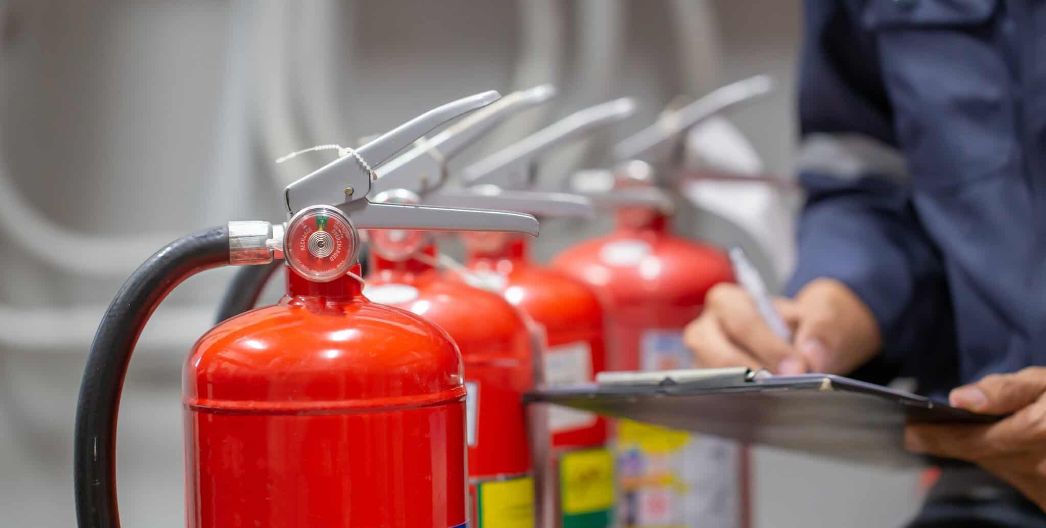 Engineer checking fire extinguishers